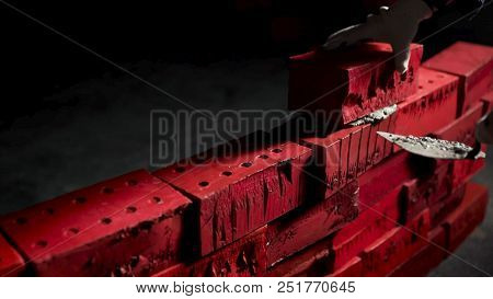 Close Up Of Industrial Bricklayer Installing Cement Bricks On Darc Room. Stock. Concept Of Self-deve