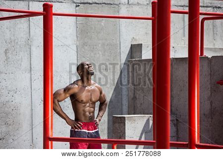 The Fit Athlete Doing Exercises At Stadium. Afro Or African American Man Outdoor At City. Pull Up Sp