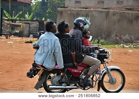 Kampala, Uganda - August 26, 2010: A Family Of Five Member Rides A Motorbike In The Kampala Slums. H