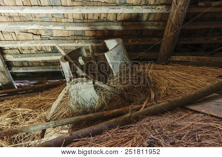 Very Old And Broken Wooden Tub Lying In The Barn Attic On Hay Straw