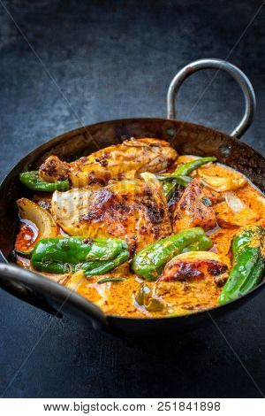 Traditional Thai kaeng massaman coconut chicken curry with jalapeno, poblano chili and sweet potatoes as closeup in a traditional bowl 