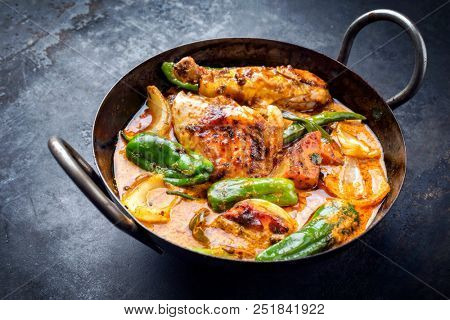 Traditional Thai kaeng massaman coconut chicken curry with jalapeno, poblano chili and sweet potatoes as closeup in a traditional bowl 