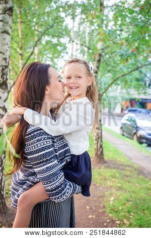 Mother And Her Little Daughter Coming To School. Adorable Little Girl Feeling Very Excited About Goi