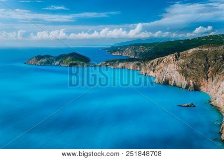 View Of Assos Village Town And Frourio Peninsular Castle Ruins On Top. Beautiful Milky Blue Bay With