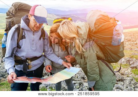 Travel Lifestyle And Survival Concept Rear View. Hiking Man And Women With Backpack Enjoys A Hike  A