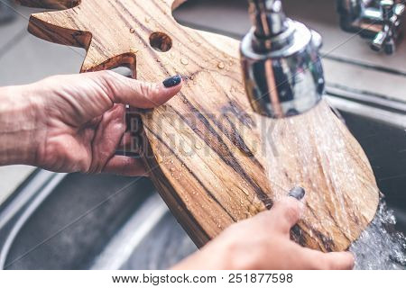 Teak Wooden Cutting Board Washing. Woman Hands Washing Wooden Cutting Board.