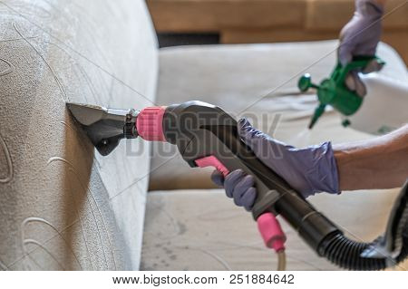 Closeup Of Upholstered Sofa Chemical Cleaning With Professionally Extraction Method. One Person Is H