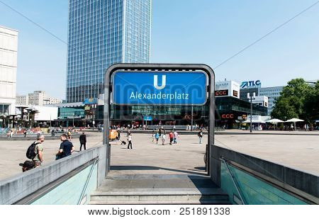 BERLIN, GERMANY - MAY 28, 2018: A view of the Alexanderplatz square, a busy public pedestrian square in Berlin, Germany, with the entrance to the underground station in the foreground