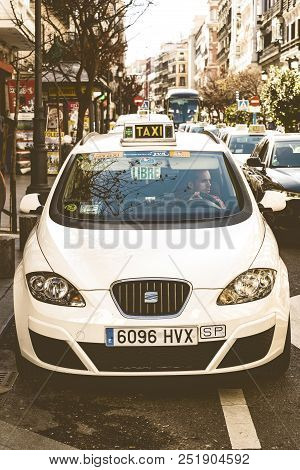 Madrid, Spain - 27 March, 2018: Taxi Of The White Color Of The City Of Madrid On City Streets.