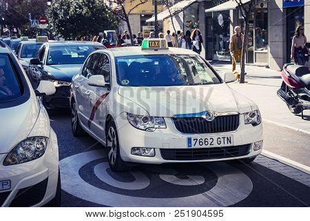 Madrid, Spain - 27 March, 2018: Taxi Of The White Color Of The City Of Madrid On City Streets.