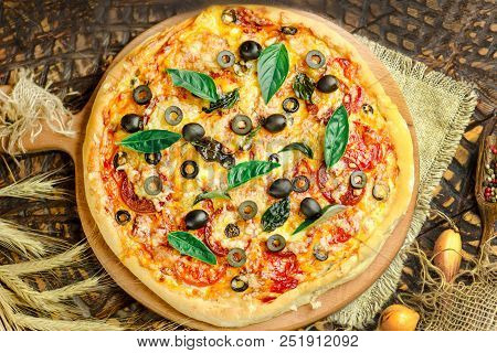 Mixed Pizza With Chicken, Pepper, Olives, Onion, Basil On Pizza Board