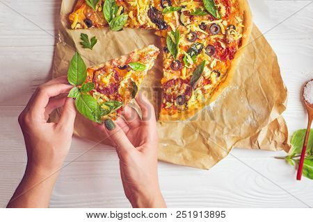Pizza And Hand Close Up Over White Background