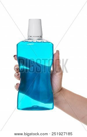 Bottle With Rinse Aid For Mouth In Hand On White Isolated Background