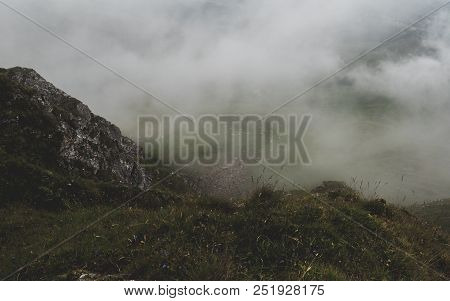 Scary Hiking Path In The Fog On Steep Mountain. Hiking Path Through Grass, Brienzer Rothorn Switzerl