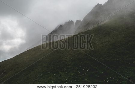 Scary Hiking Path In The Fog On Steep Mountain. Hiking Path Through Grass, Brienzer Rothorn Switzerl