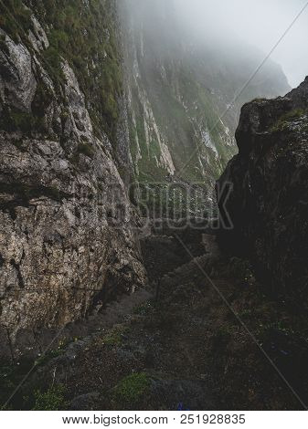 Scary Steep Hiking Path With Stairs On Steep Mountain. Hiking Path Sign On A Stone, Brienzer Rothorn