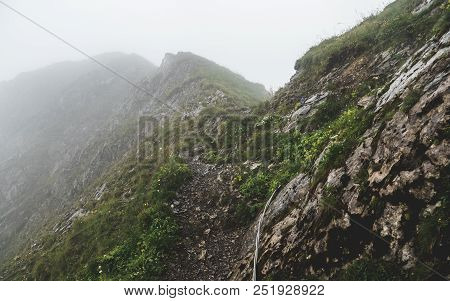 Scary Hiking Path Covered In Fog On The Ridge Of A Mountain In The Swiss Alps, Brienzer Rothorn Swit