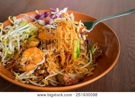 Thai Fried Noodles With Shrimp And Vegetables ,pad Thai On A Wooden Table