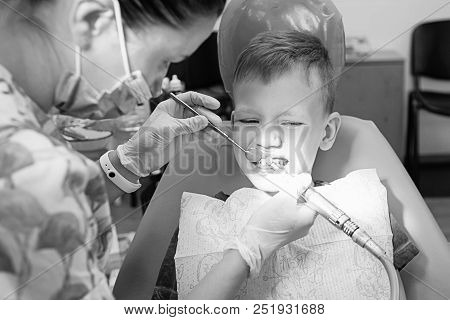 A Little Boy At A Dentist's Reception In A Dental Clinic.