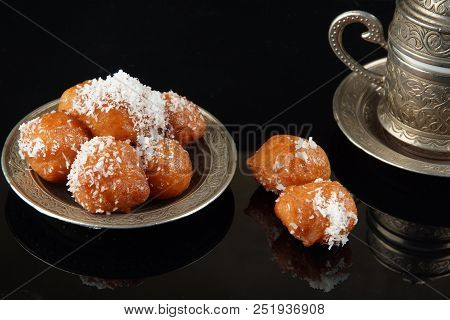 Two Pieces Of Turkish Lakuma Lie On The Table, Next To The Coffee.