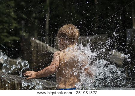 Baby Boy In Fountain. Concept Of Happiness And Carefree Childhood.