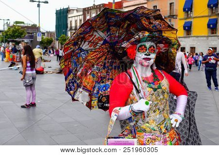 MEXICO CITY,MEXICO - JULY 12,2018 : Mexican woman wearing a colorful Catrina costume in Mexico City