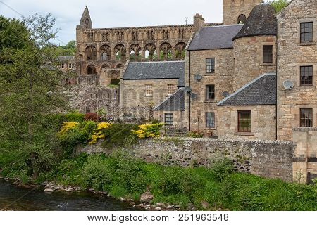 View At Ruins Of Jedburgh Abbey In Scottish Borders. In Front Jed Water River
