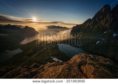 Breidtinden Summit Over Cloudy Mefjorden And Two Lakes In Sunset Light, Senja, Norway