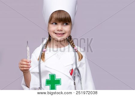 Little Doctor Girl Playing And Measuring Temperature Isolated On White Background