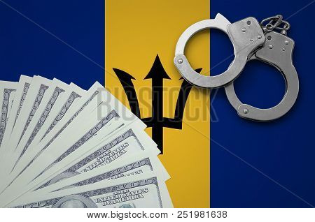Barbados Flag  With Handcuffs And A Bundle Of Dollars. The Concept Of Illegal Banking Operations In 