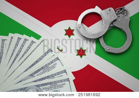 Burundi Flag  With Handcuffs And A Bundle Of Dollars. The Concept Of Illegal Banking Operations In U