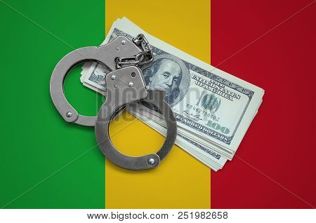Mali Flag  With Handcuffs And A Bundle Of Dollars. Currency Corruption In The Country. Financial Cri