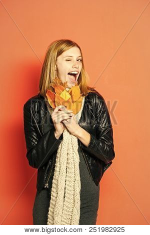 Season And Autumn Holiday. Girl With Orange Leaves On Orange Background. Woman With Autumn Leaves In