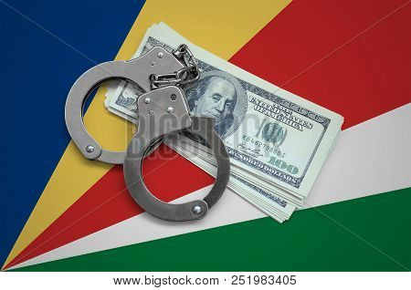 Seychelles Flag  With Handcuffs And A Bundle Of Dollars. Currency Corruption In The Country. Financi