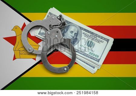 Zimbabwe Flag  With Handcuffs And A Bundle Of Dollars. Currency Corruption In The Country. Financial
