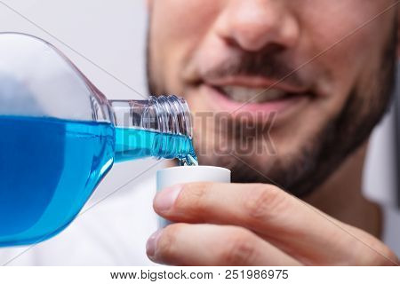 Man Pouring Mouthwash In To Cap