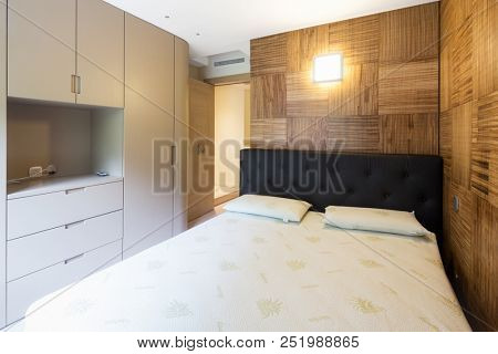 Bedroom with parquet in modern apartment. Nobody inside.