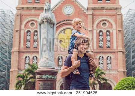 Father And Son In The Background Notre Dame De Saigon Cathedral, Build In 1883 In Ho Chi Minh City, 
