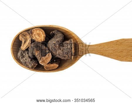 Dry Bistorta Root In Wooden Spoon On White Background