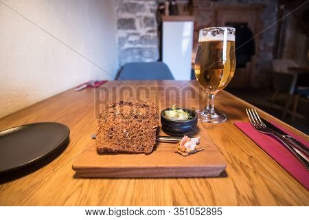 Blatic Bread With Beer And Butter On Wooden Plate
