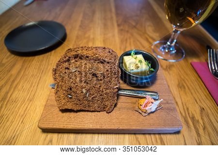 Blatic Bread With Butter On Wooden Plate