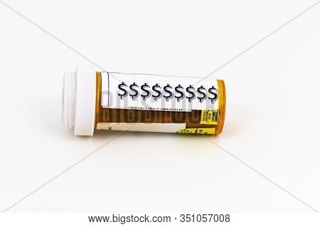 Prescription Pill Bottle Lying Sideways With A White Background And Dollor Bill Logos On The Bottle 
