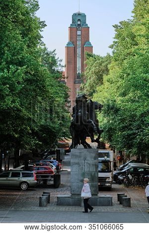 Lahti, Finland - August 6, 2019: On The Foreground Statue Of Two Finnish Hakkapeliitta Returning On 