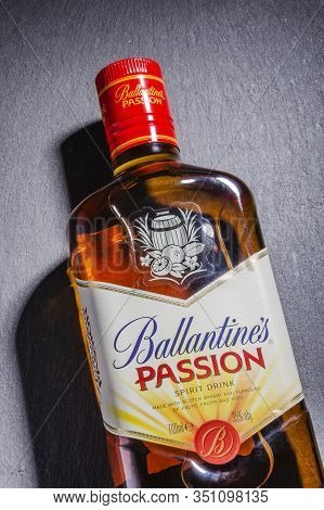 Ballantines Passion Spirit Drink On Stone Slate Background. Ballantines Is Blended Scotch Whisky Pro