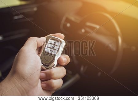 Driver's Hand Holding The Car Keyless Remote.