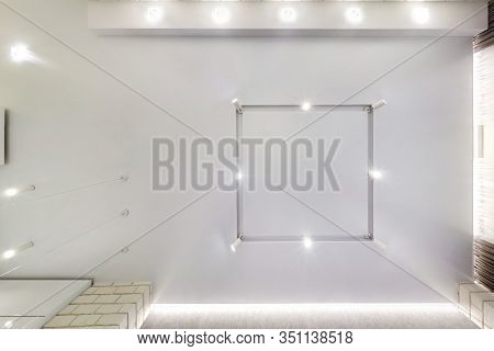 Look Up On Suspended Ceiling With Halogen Spots Lamps And Drywall Construction In Empty Room In Apar