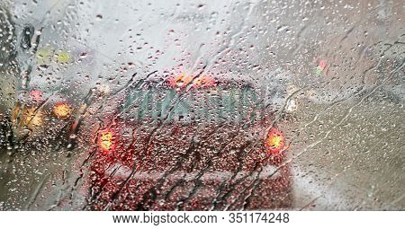 View From The Car Windscreen During Rain And Wet Snow. Poor Visibility While Driving Around The City
