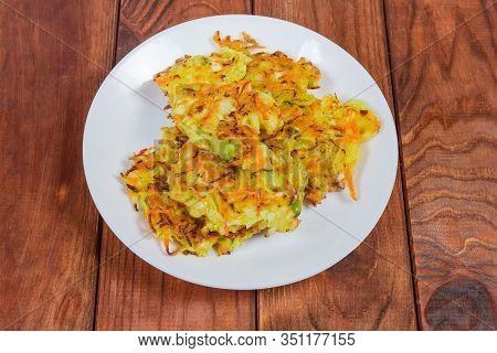 Fried Savory Cabbage Pancakes On White Dish On The Wooden Rustic Table