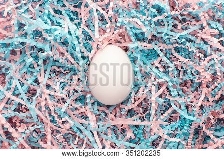 Easter Creative Composition. Flat Lay With Easter Egg And Kraft Paper Pink And Blue Filler . Minimal