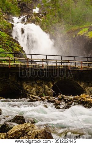 Norwegian Landscape. Waterfall Latefoss Latefossen With Stone Arched Bridge Road, Odda Hordaland Nor